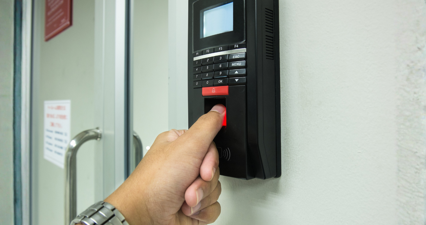 Biometric attendance system in Qatar: a fingerprint terminal beside a door